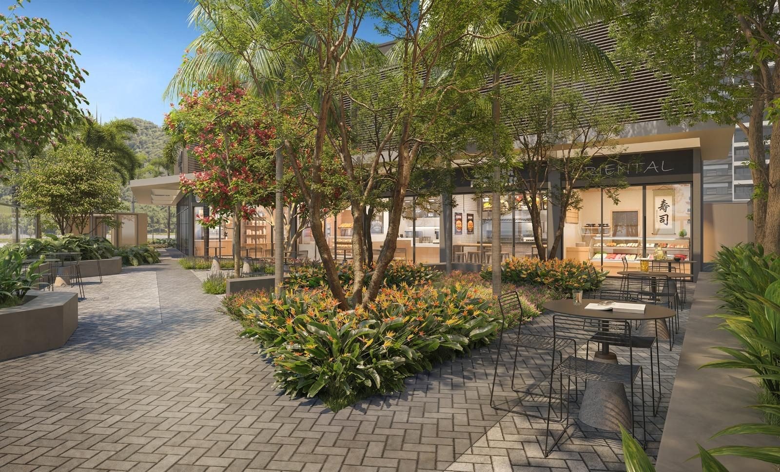 Wooded area with tables in front of the Ilha Stay Mall shops