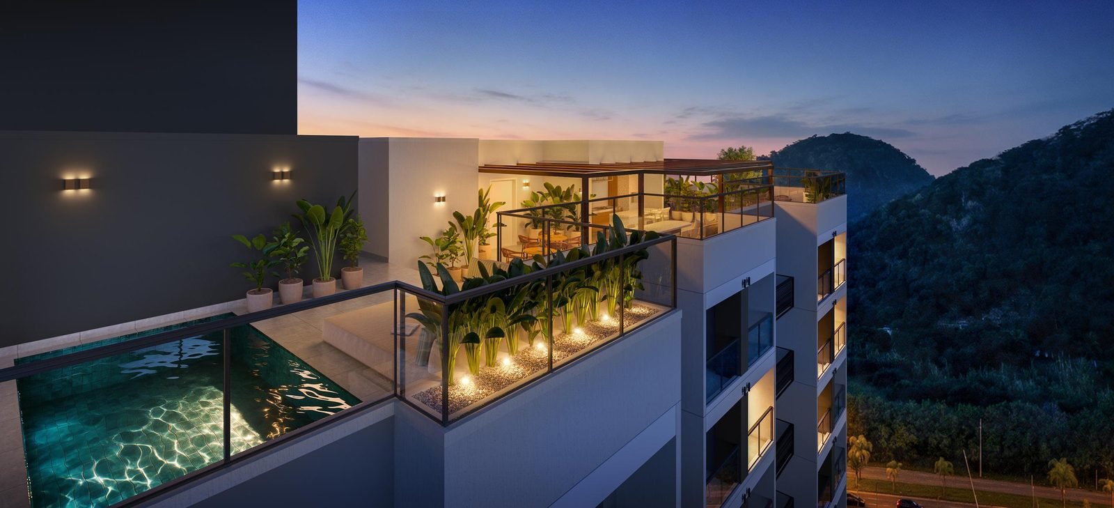 Ilha Stay Home Resort rooftop at dusk, with a pool and mountain views